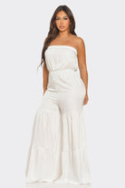 Elegant strapless vacation jumpsuit in white with tiered detail for a stylish summer look