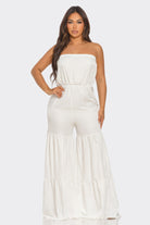 Elegant white strapless vacation jumpsuit with flowy wide legs for a stylish summer look