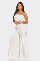 White strapless vacation jumpsuit with tiered design for summer outings and beach days