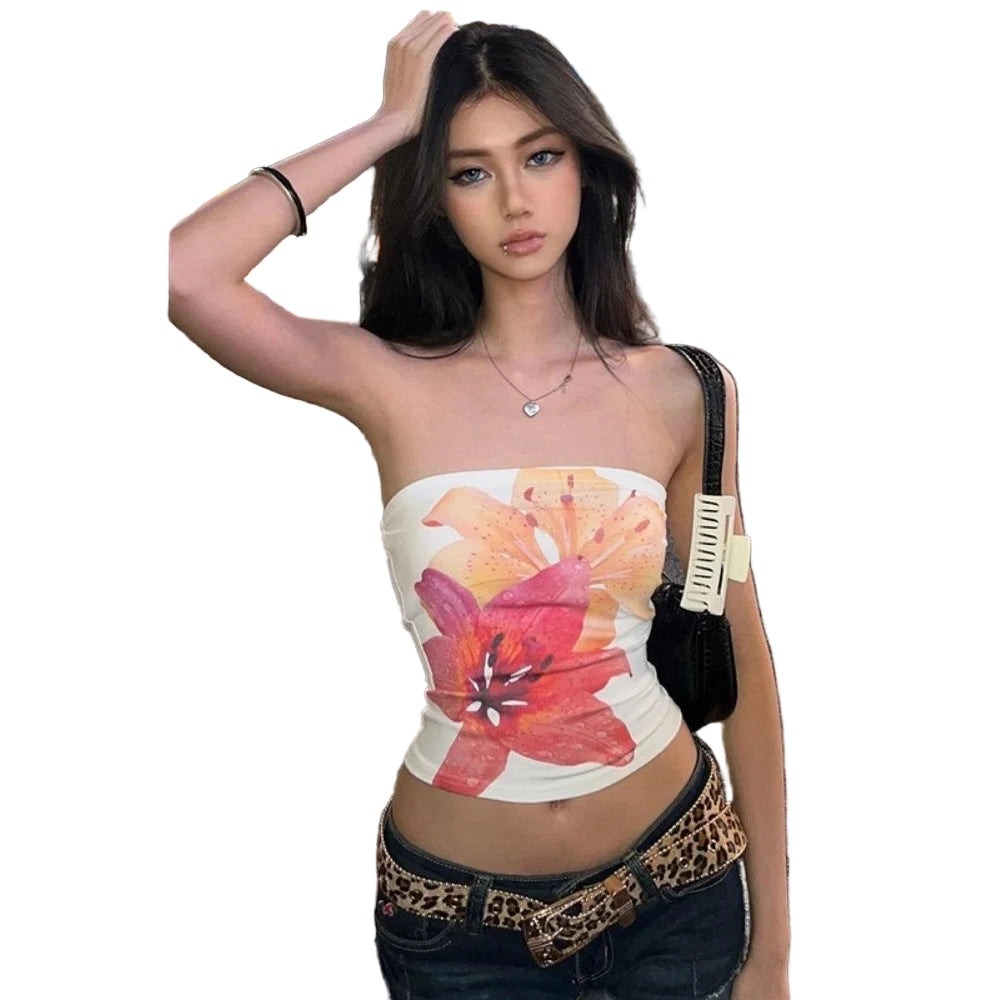 Young woman wearing summer strapless crop top with large floral print standing on city street at night