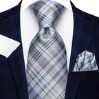 Men's blue plaid suit with a white pocket square, learn how fold a pocket square
