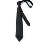 Black men's tie with geometric pattern, perfect for how to tie men's tie