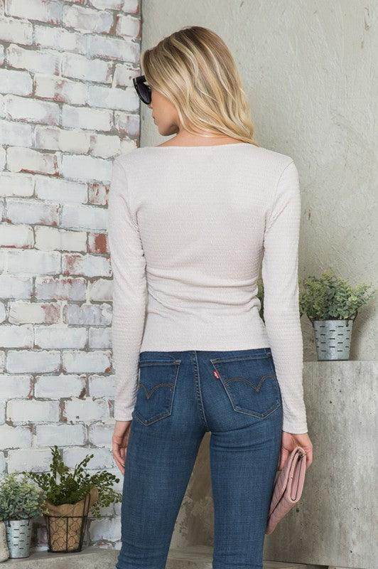 Back view of a women's versatile jersey top in light color paired with jeans for a casual look