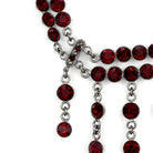 Vintage inspired silver jewelry necklace with red gemstones and intricate details