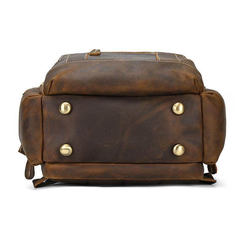 Vintage leather backpack with durable brass accents and sturdy bottom for lasting use