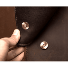 Close-up of vintage leather business backpack with durable snap fasteners and rich texture for stylish professionals