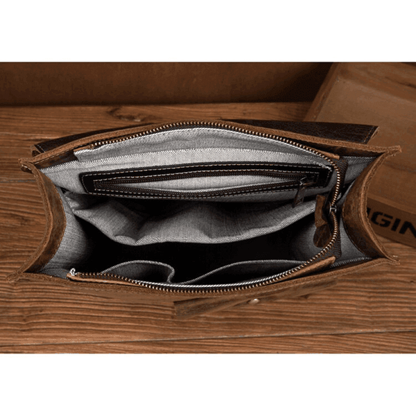 Inside view of a vintage leather business backpack featuring multiple pockets and compartments