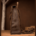 Side view of a vintage leather business backpack with adjustable straps and premium finish