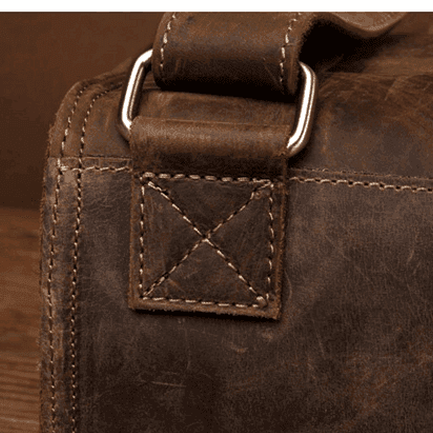 Close-up of vintage leather business backpack showing sturdy stitching and durable hardware