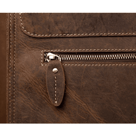 Close-up of a vintage leather business backpack showcasing its sturdy zipper and detailed stitching