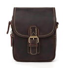Vintage leather sling bag with a secure buckle closure and durable stitching for everyday use