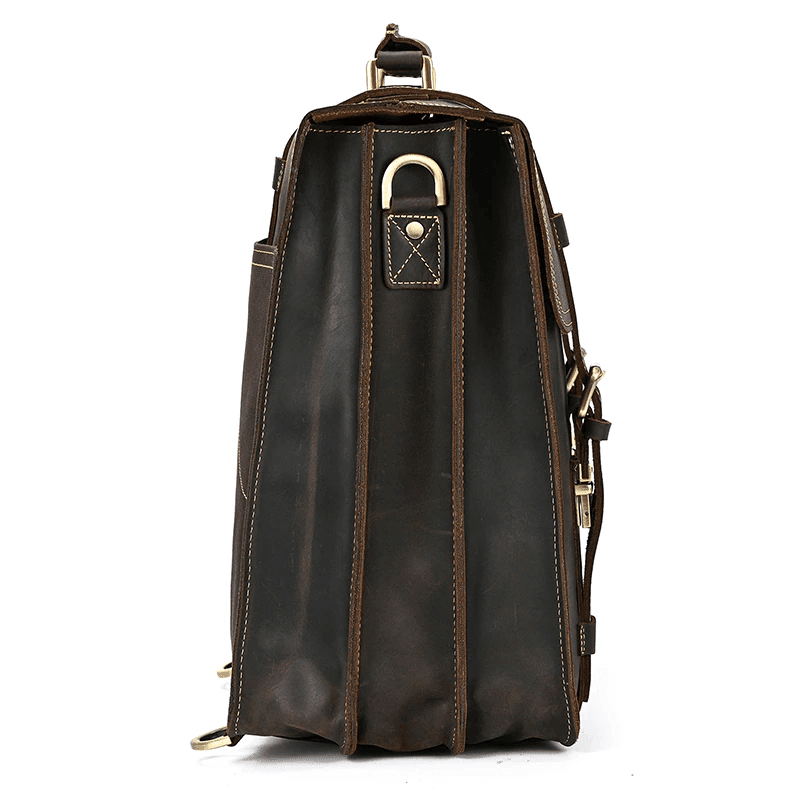 Side view of a vintage leather travel backpack with multiple compartments and sturdy hardware