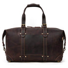 Vintage leather travel bag with sturdy handles and adjustable shoulder strap for versatile use
