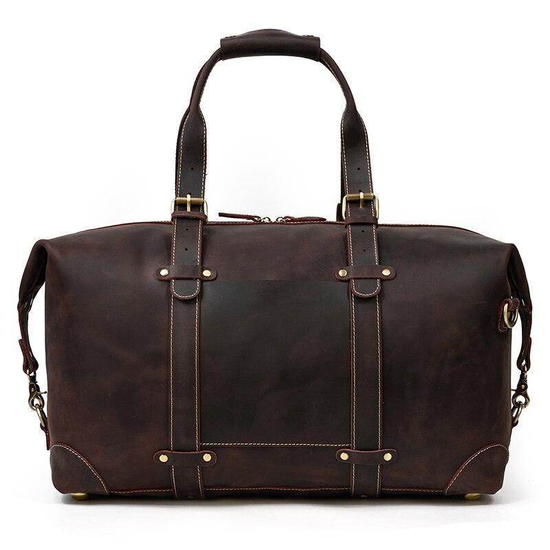 Vintage leather travel bag with sturdy handles and adjustable shoulder strap for versatile use