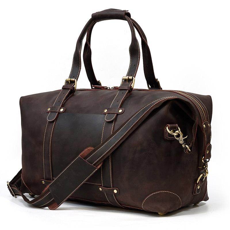 Vintage leather travel bag in dark brown with sturdy handles and adjustable shoulder strap for stylish trips