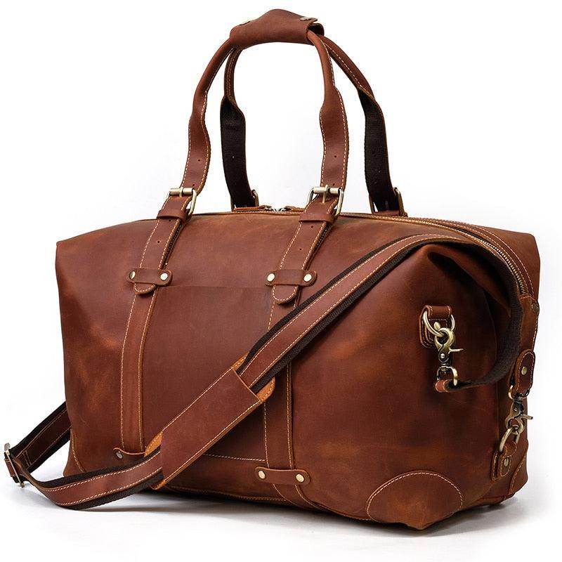 Vintage leather travel bag in rich brown color with sturdy handles and adjustable strap for easy carrying