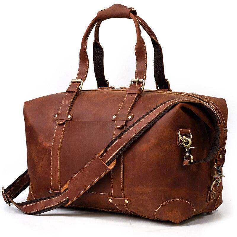Vintage leather travel bag with sturdy handles and an adjustable shoulder strap for convenient travel