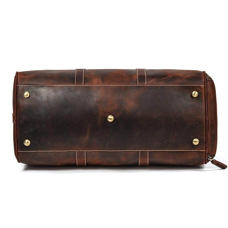 Vintage leather travel duffle bag with brass feet and a rich brown finish for stylish travel