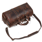 Vintage leather travel duffle with a spacious interior and adjustable shoulder strap for stylish trips