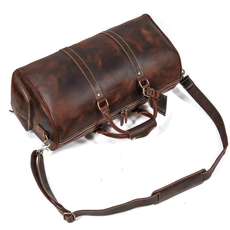 Vintage leather travel duffle with a spacious interior and adjustable shoulder strap for stylish trips