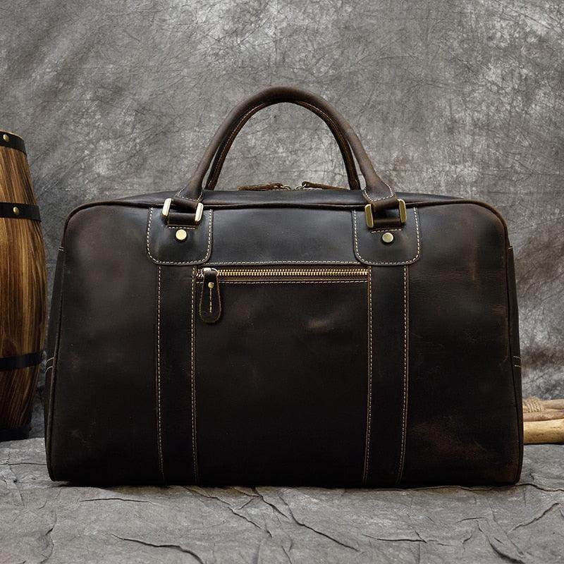 Vintage leather weekender bag with durable handles, ideal for travel and weekend getaways