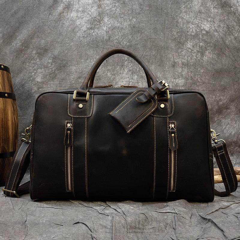 Vintage leather weekender bag with dual zip pockets and a detachable luggage tag for stylish travel