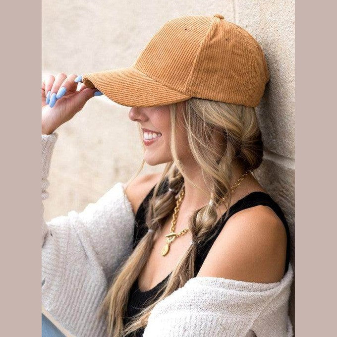 Aili's Corner vintage style ball cap in corduroy worn by a smiling woman with braids