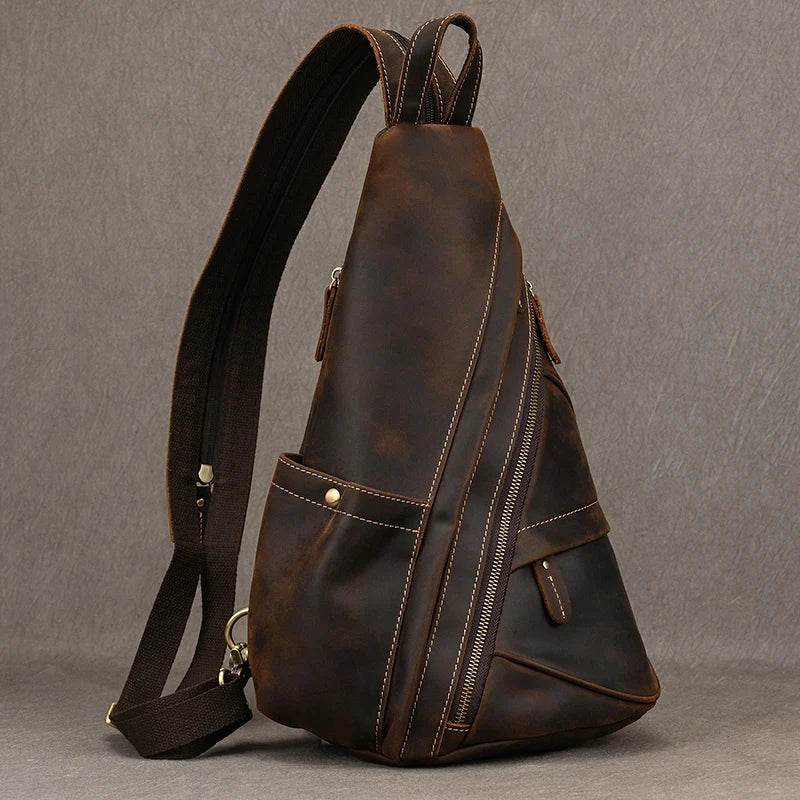 Vintage style sling bag for men made from durable leather with multiple zippered pockets