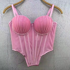 Pink sexy clubwear bustier shirt with structured cups and adjustable straps hanging on wooden hanger