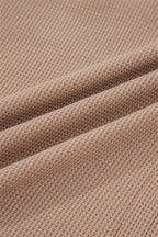 Soft fabric close-up of a JUNIPER BLVD waffle knit henley top in a warm beige tone