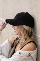 Stylish women's warm boucle ball cap in black, perfect for casual outfits and chilly days.
