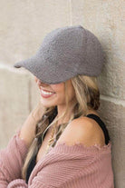Stylish woman wearing a warm boucle ball cap in gray, perfect for casual outings