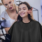 Black waterproof hairdressing cape for salon use during haircuts