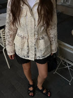 Women's lace jacket and black shorts, perfect wedding guest outfit summer