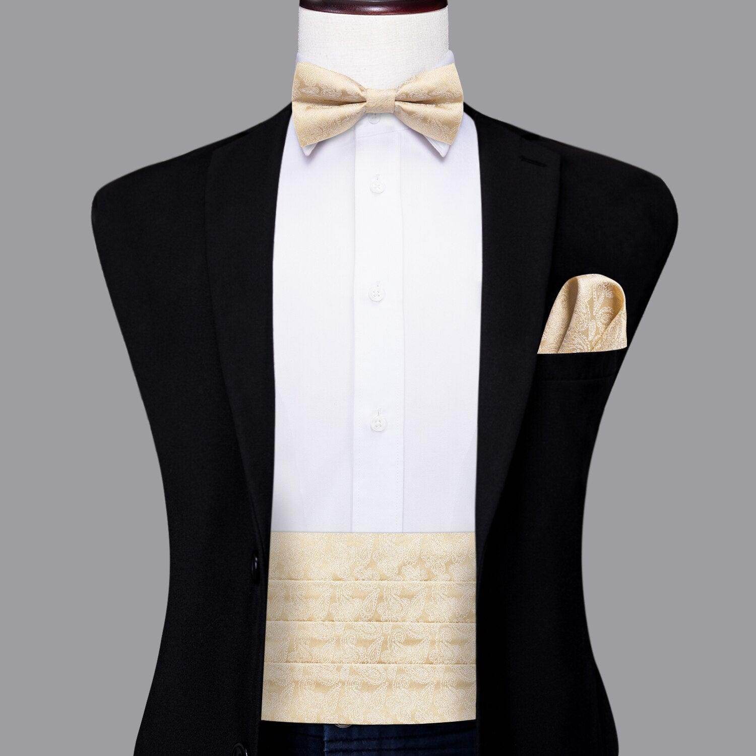 Men's wedding tuxedo set featuring cream bow tie, pocket square, and formal waistcoat for elegant occasions