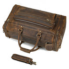 Brown leather weekend bag with multiple zippered pockets for travel