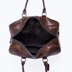 Brown leather weekend bag with spacious interior for travel