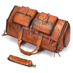Brown leather weekender bag with two outer pockets for travel