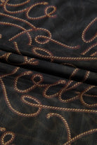 Close-up of JUNIPER BLVD western rodeo mesh top featuring a stylish rope pattern on dark fabric