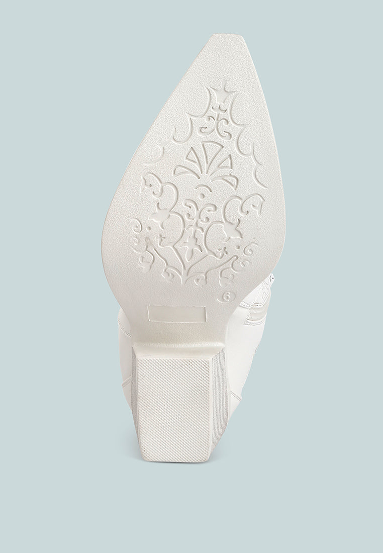Sole of white ankle cowboy boots by London Rag International featuring detailed engravings