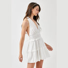 Mustard Seed white halter neck smocked dress with tiered skirt worn by woman