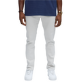 Men wearing slim fit vacation jeans men in white from VacationGrabs paired with white sneakers