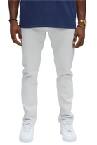 Men wearing slim fit vacation jeans men in white from VacationGrabs paired with white sneakers