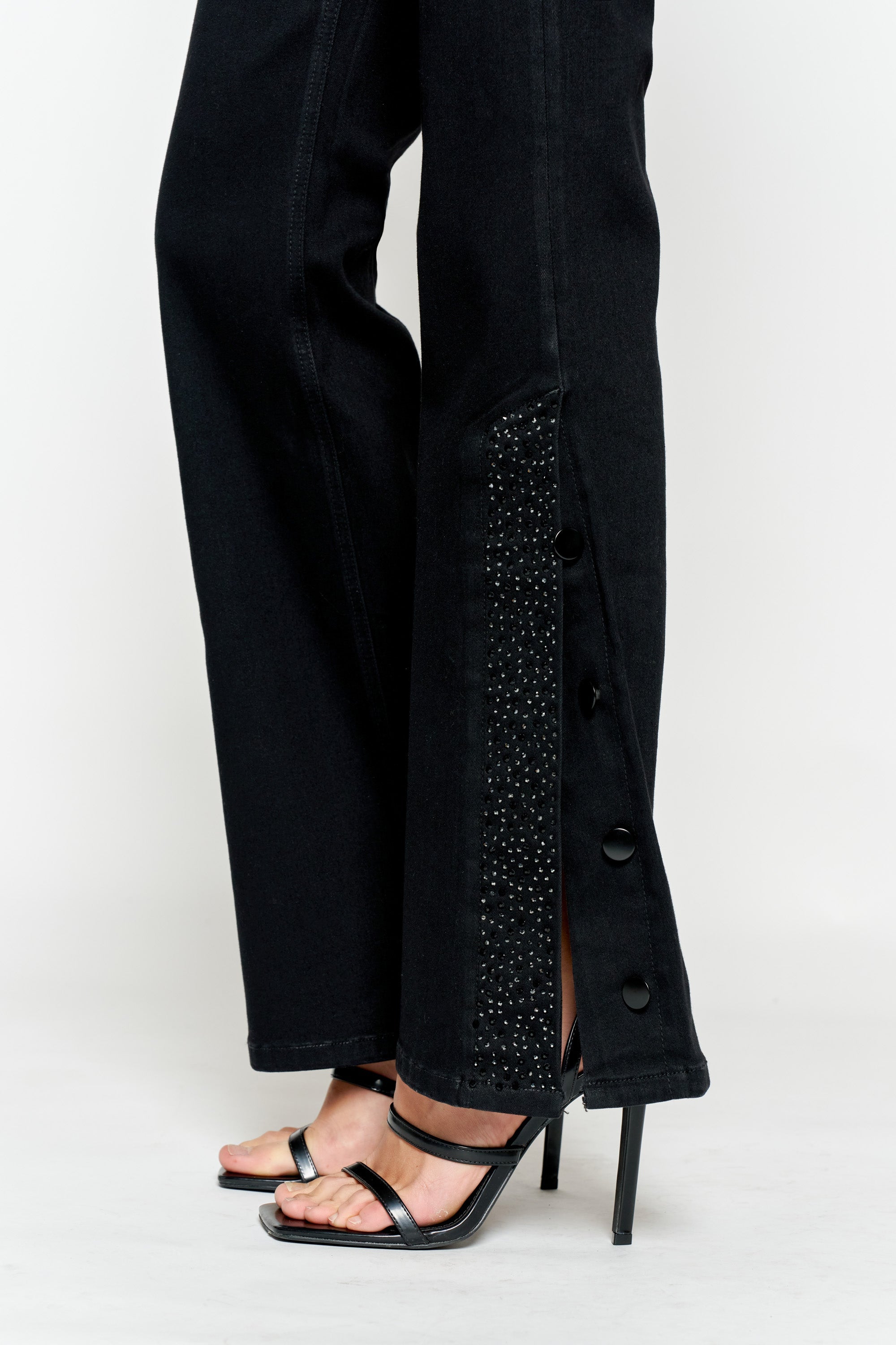 Women's black wide-leg jeans with decorative button side detail