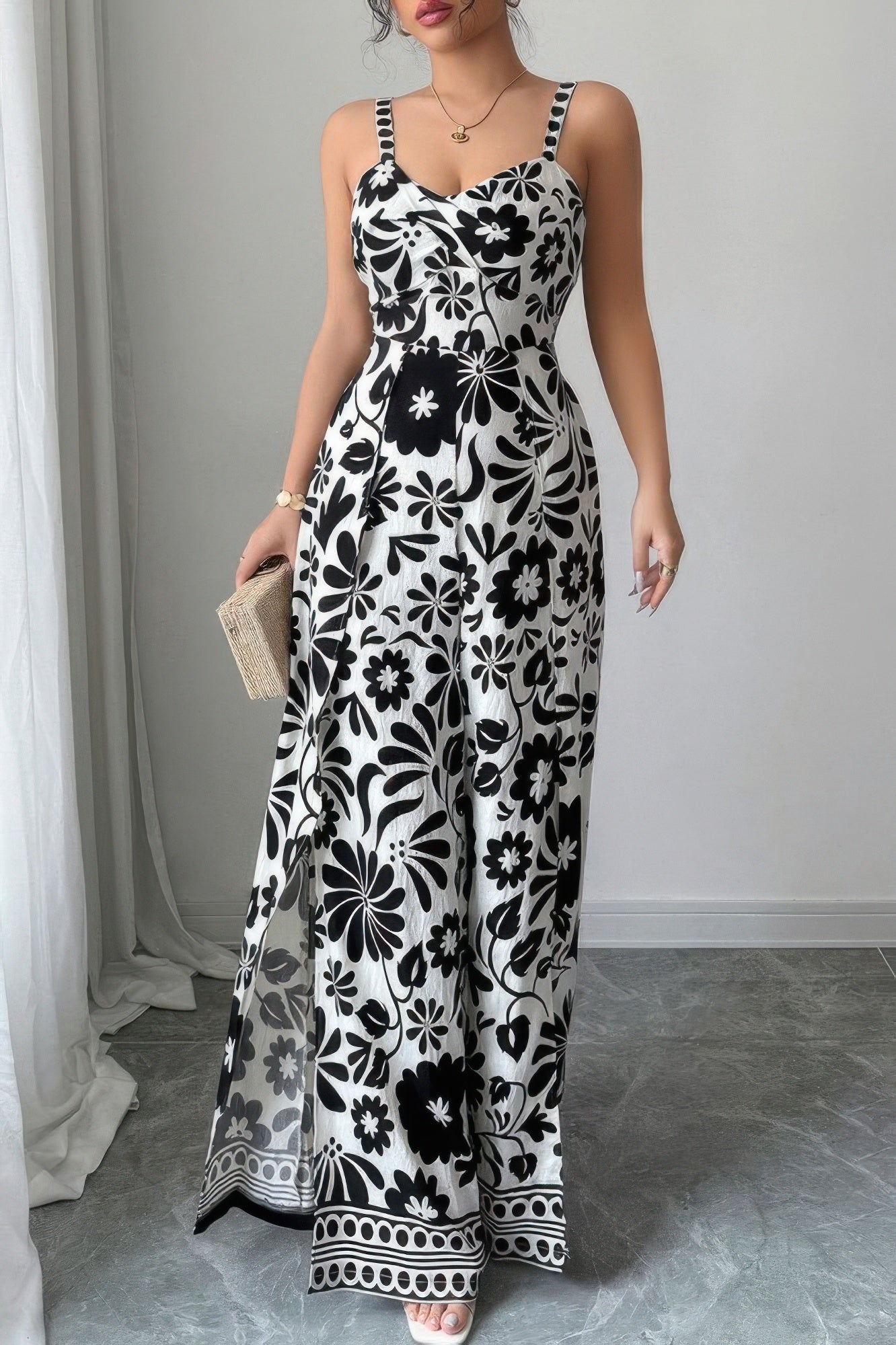 Stylish black and white floral wide leg vacation jumpsuit with a flattering fit for summer outings