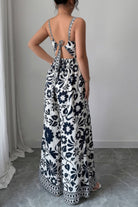 Back view of a stylish wide leg vacation jumpsuit featuring a floral print and tie detail