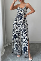 Stylish wide leg vacation jumpsuit in black and white floral pattern with slit detail