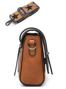 Side view of a Sifides wide strap shoulder bag in brown leather with a stylish star-patterned strap