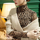 Leopard print mesh sheer top women styled with cozy beige knit shawl and pearl earrings indoors
