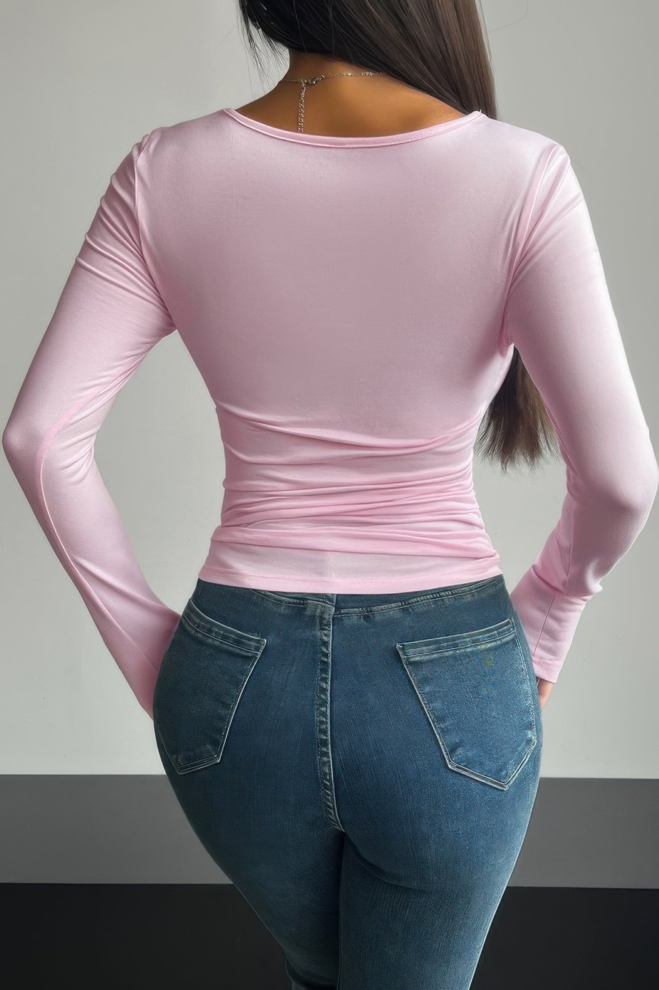 Fashionable women's plain black ruched tee for women styled with jeans, showcasing a modern fit